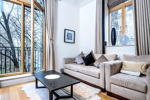 Polished wooden flooring, striking furniture and white paint give the spacious, well-lit reception room in this recently sold London property an elegant look.